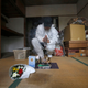 After the cleaning, incense and flowers were put where the body was found. A photo of the man is placed near where he had laid his head. A stain remains on the ground.